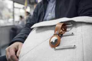 A-man-traveling-on-bus-with-airtag-2-on-his-white-bag
